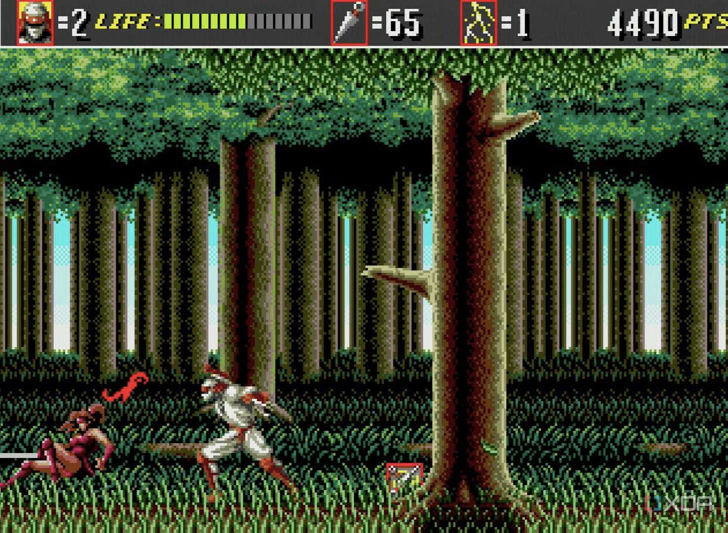 A player fighting off a surprise attack while a power up lies on the ground.