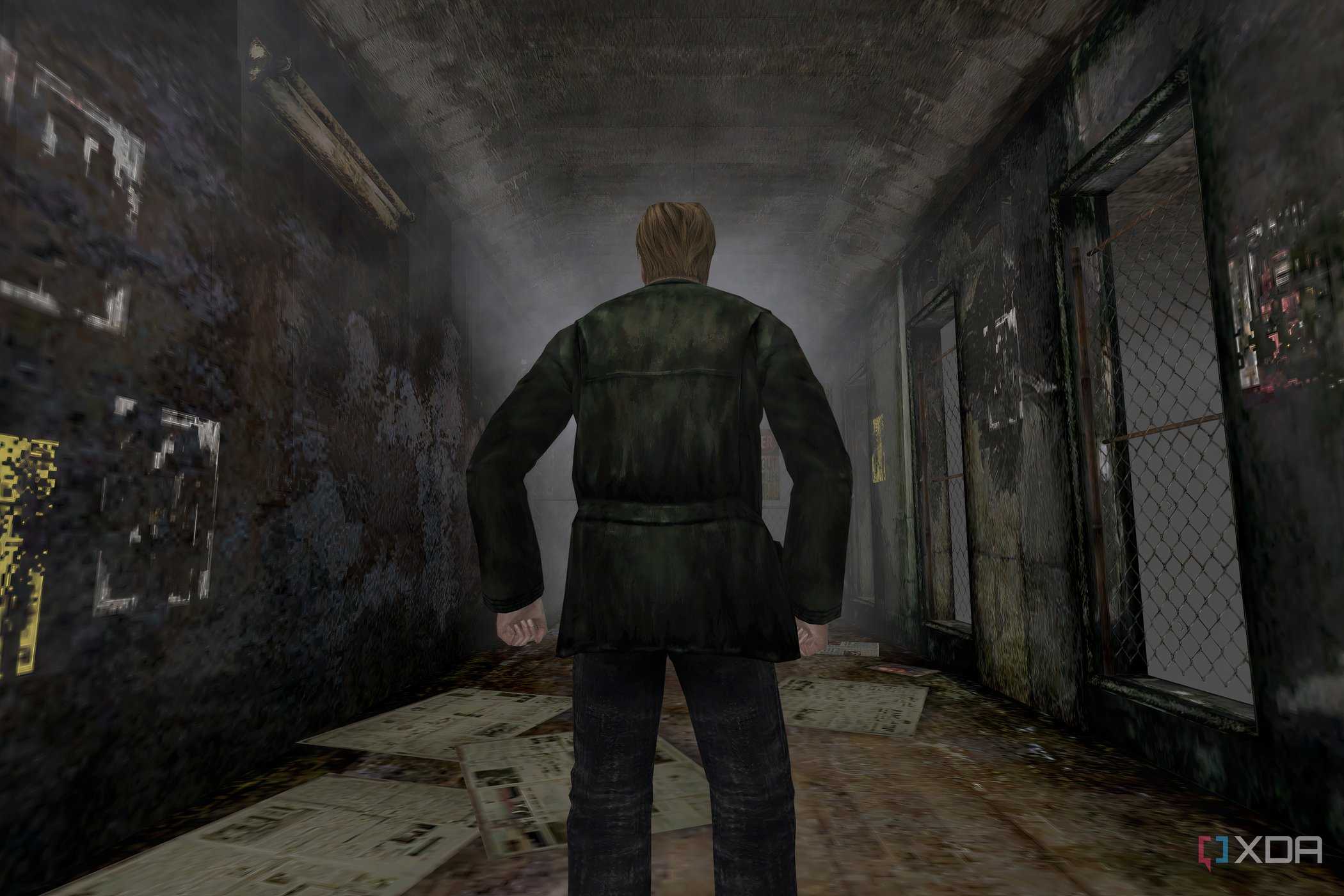 An in-game screenshot from the game Silent Hill 2, showing a man standing in the middle of a dingy alley.