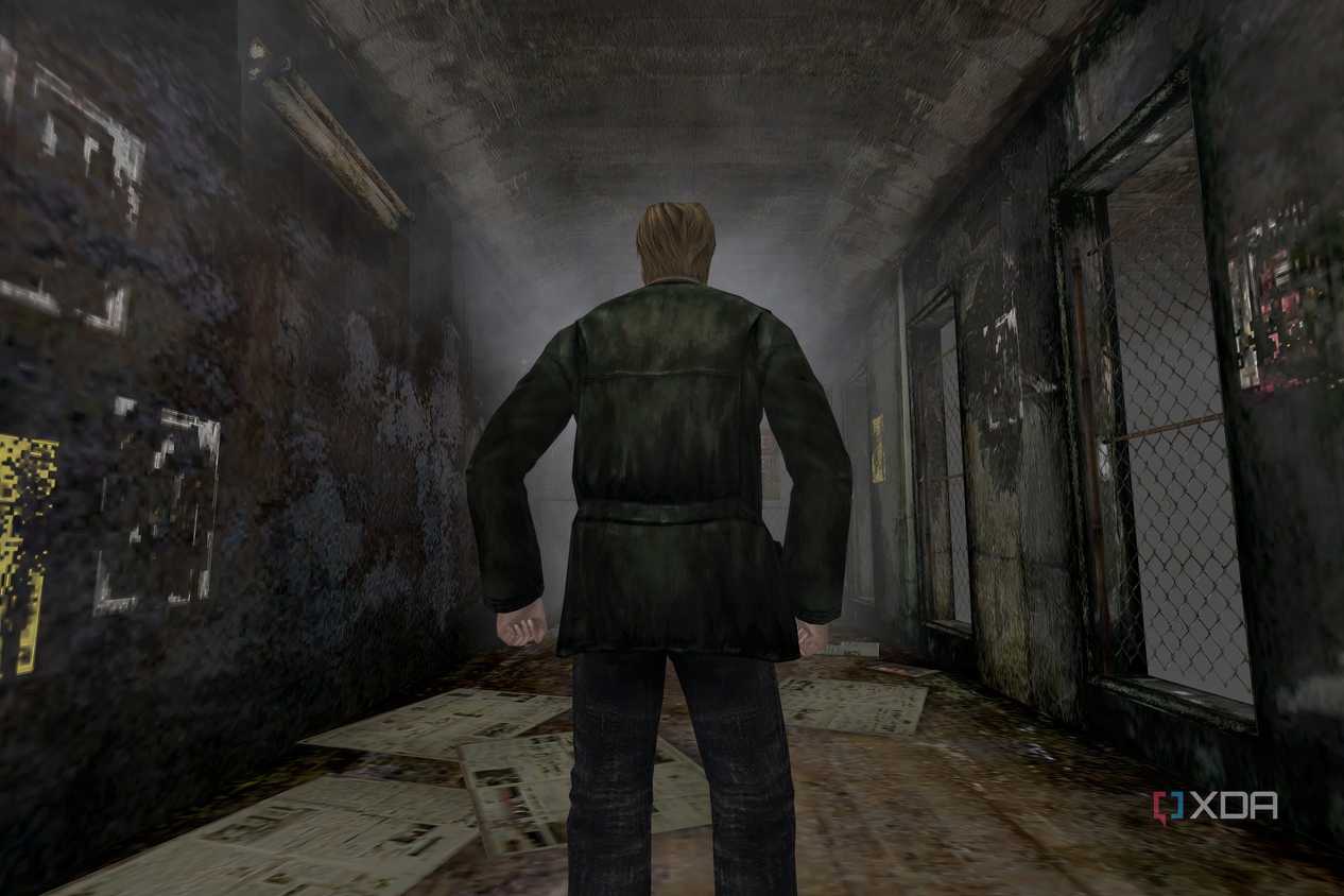 An in-game screenshot from the game Silent Hill 2, showing a man standing in the middle of a dingy alley.