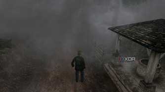An in-game screenshot from the game Silent Hill 2, showing a man standing next to a dilapidated gazebo while surrounded by thick fog.