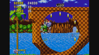 A screenshot of Sonic racing around a loop and collecting rings.