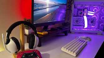 White Sony Inzone headsets with Cosmic Red DualSense controller sat on a desk with a gaming PC.