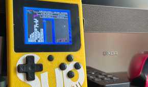 An image of a NES-rom Tetris game being played on a knock-off Game Boy.