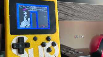 An image of a NES-rom Tetris game being played on a knock-off Game Boy.