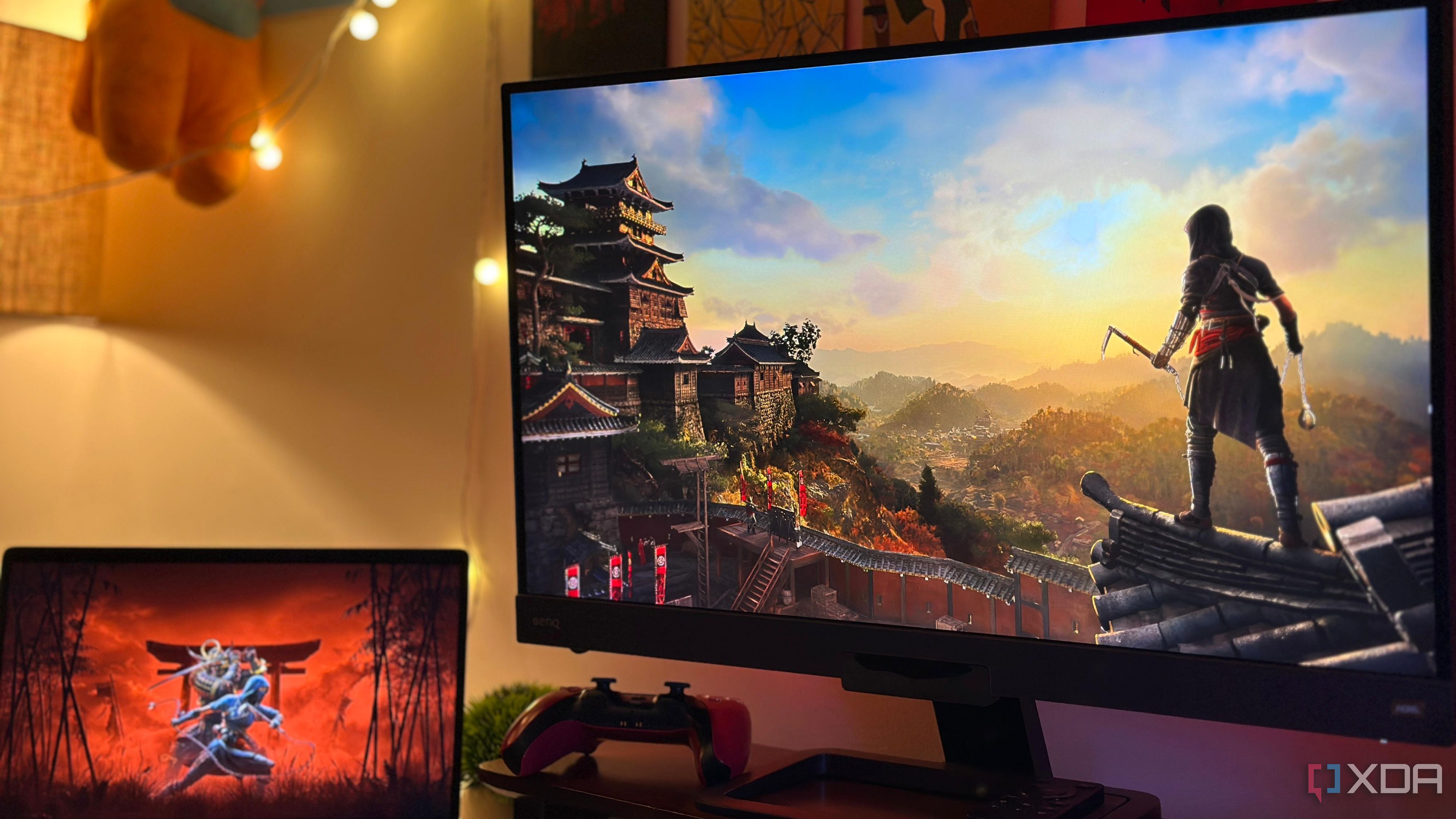 An image of a monitor and another smaller screen with posters of Assassin's Creed Shadows.