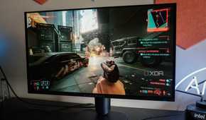 Alienware AW2725Q on a desk running Cyberpunk 2077