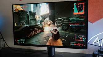 Alienware AW2725Q on a desk running Cyberpunk 2077
