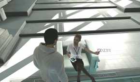 An image from the game Assassins' Creed, showing Desmond Miles talking to Lucy.