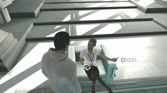 An image from the game Assassins' Creed, showing Desmond Miles talking to Lucy.
