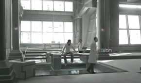 An image from the game Assassins' Creed 1, showing Desmond Miles captive at Abstergo Industries with Warren Vidic.