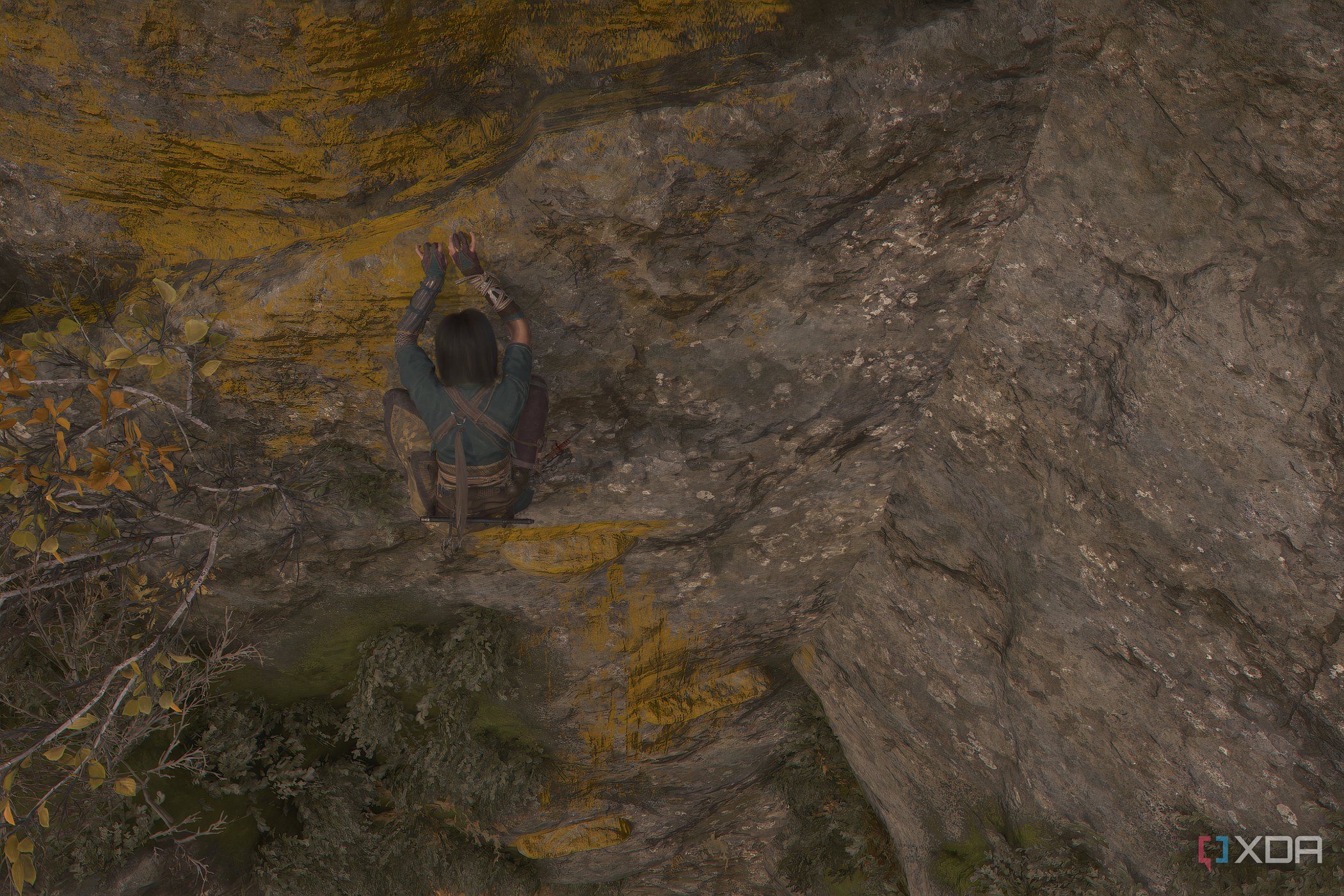 A screenshot from Assassin's Creed Shadows, showing Naoe climbing across yellow-painted handholds on a mountain face.