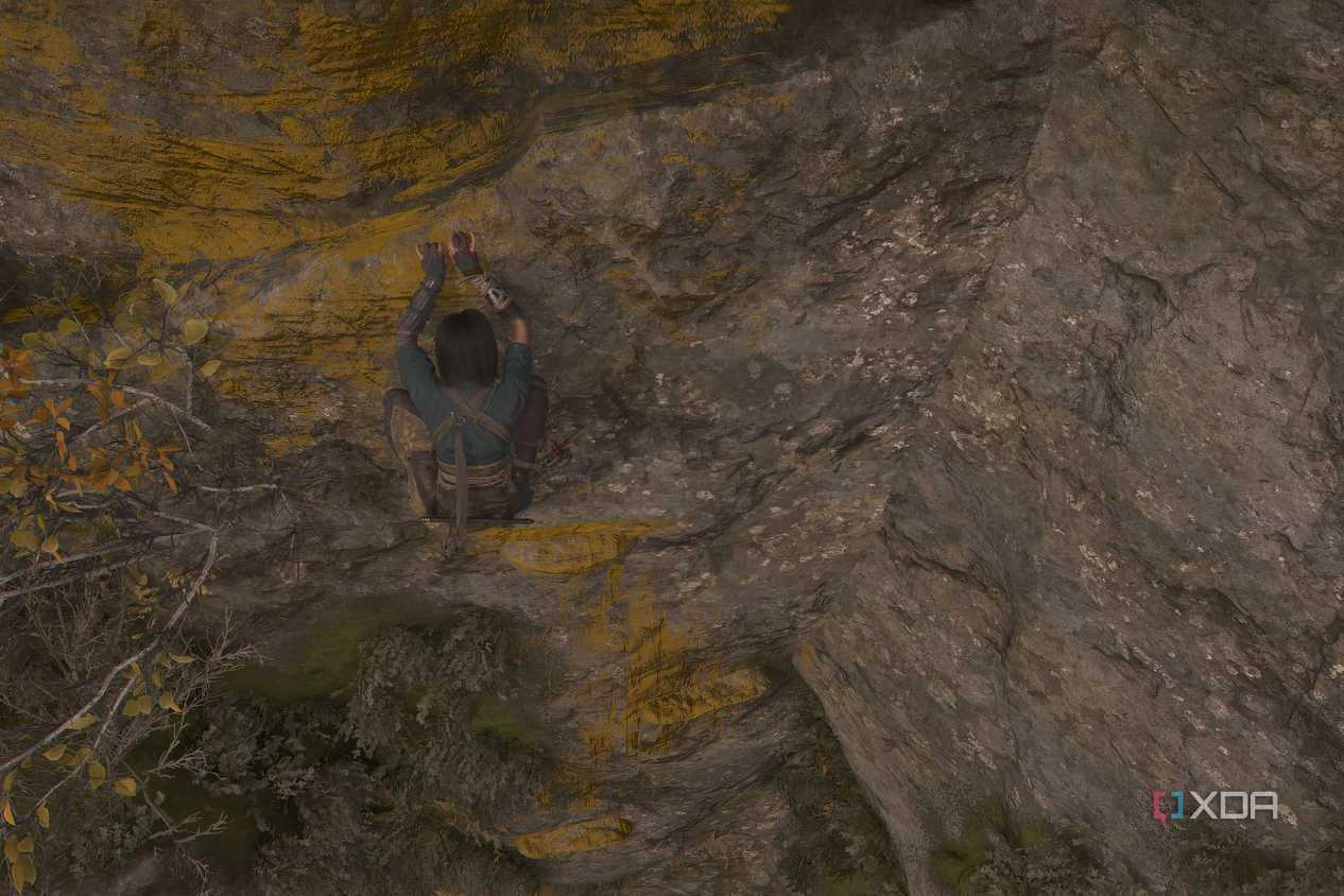 A screenshot from Assassin's Creed Shadows, showing Naoe climbing across yellow-painted handholds on a mountain face.