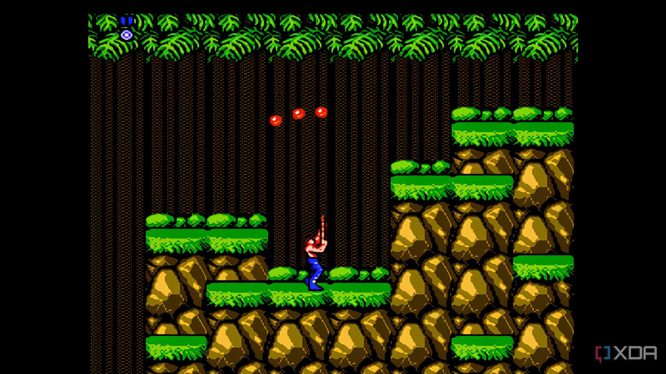 A screenshot from the game "Contra", showing the pler character shooting three bullets into the air above.
