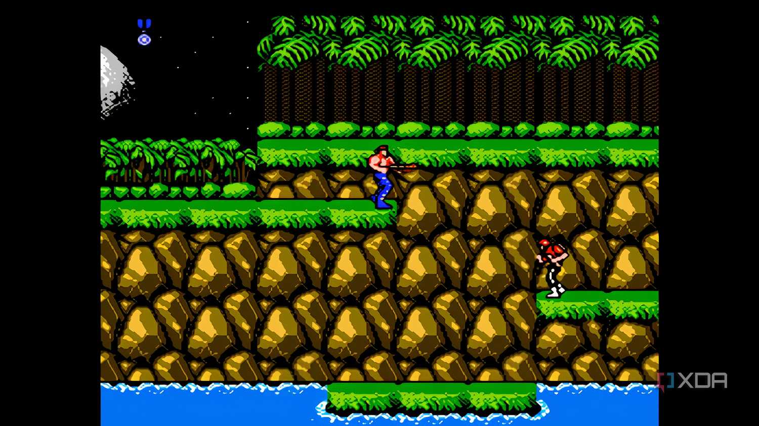 A screenshot from the game "Contra", showing the player character standing in the game's first stage of a forest.