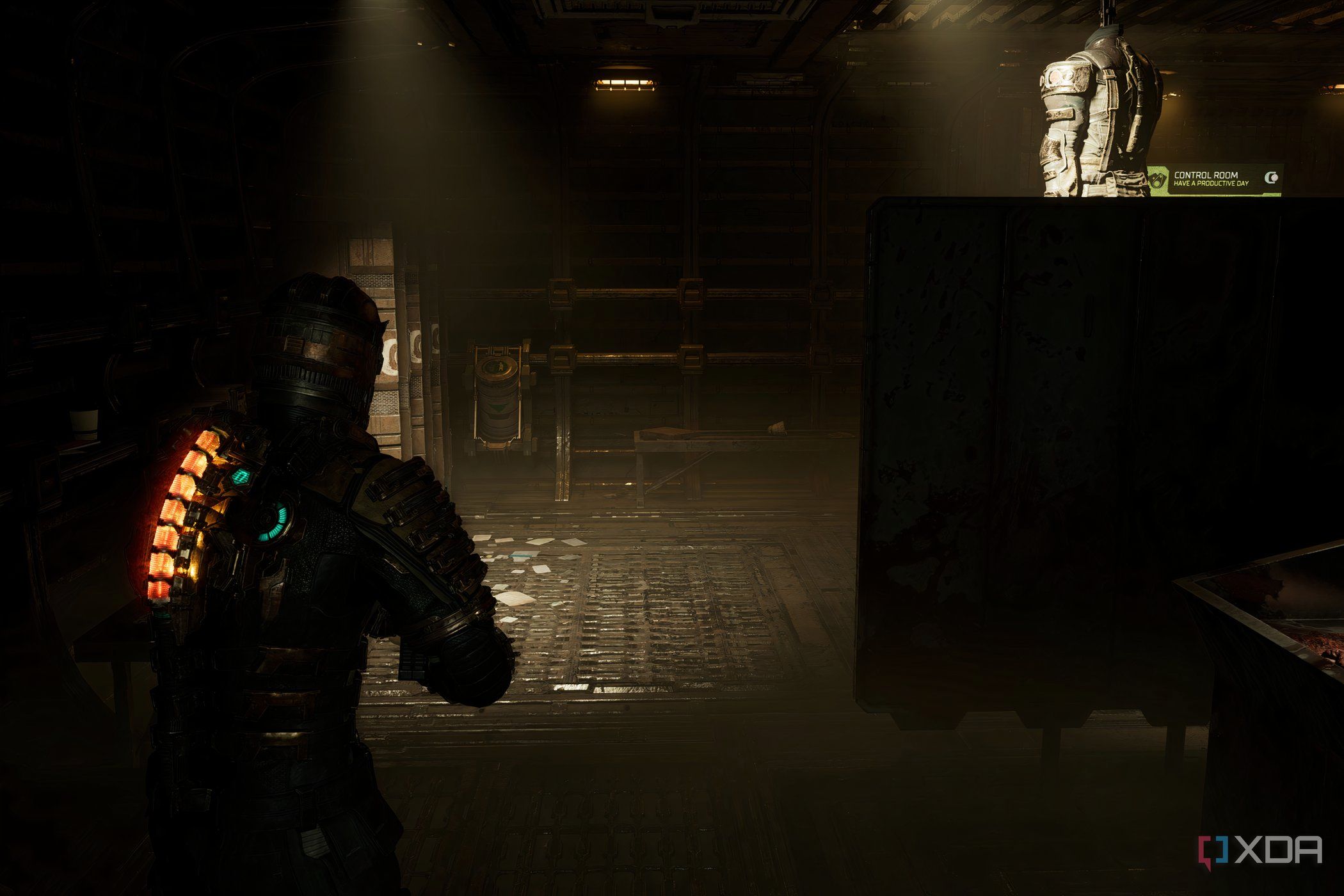 An image from 2023's Dead Space, showing the player character walking in a dark room.