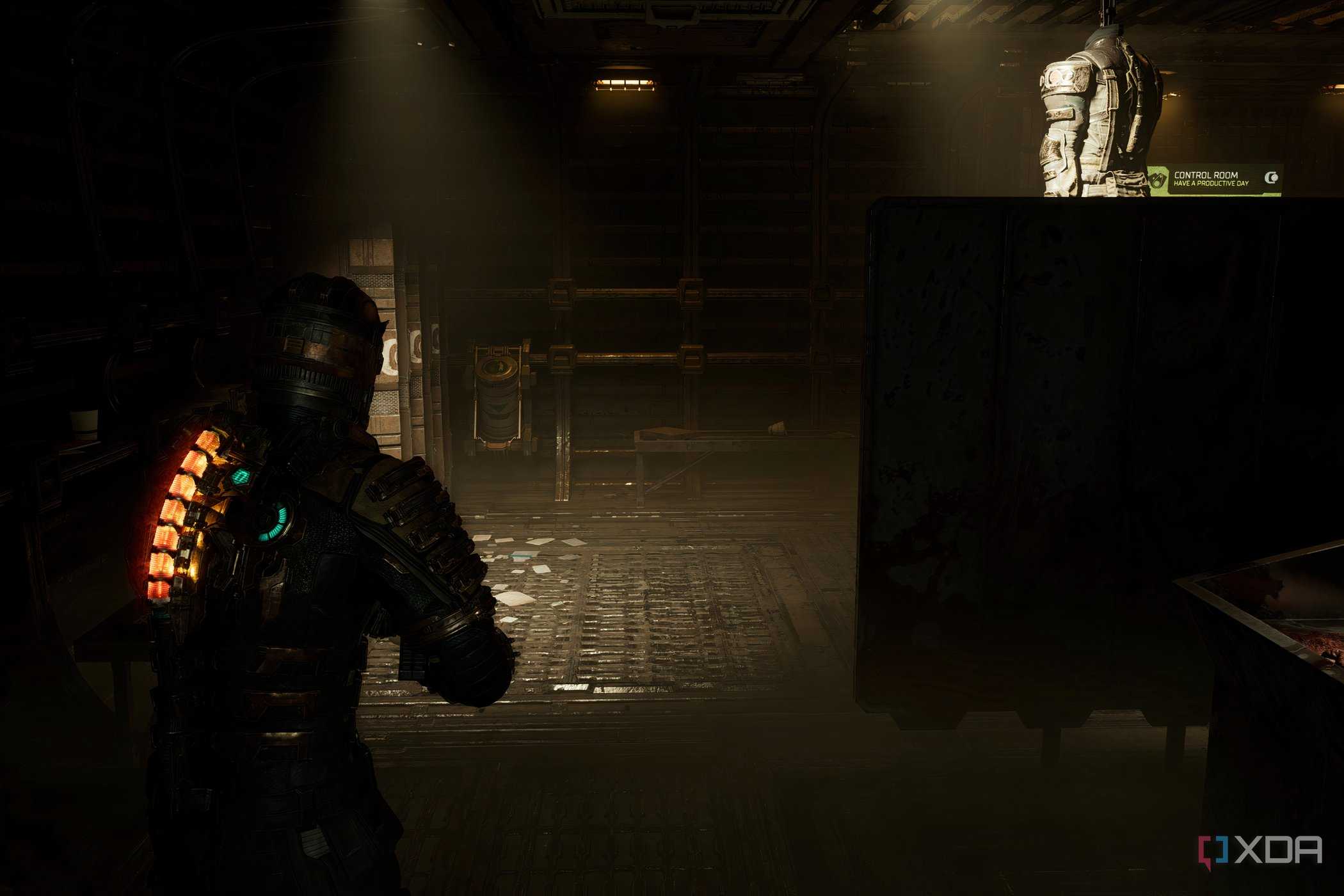 An image from 2023's Dead Space, showing the player character walking in a dark room.