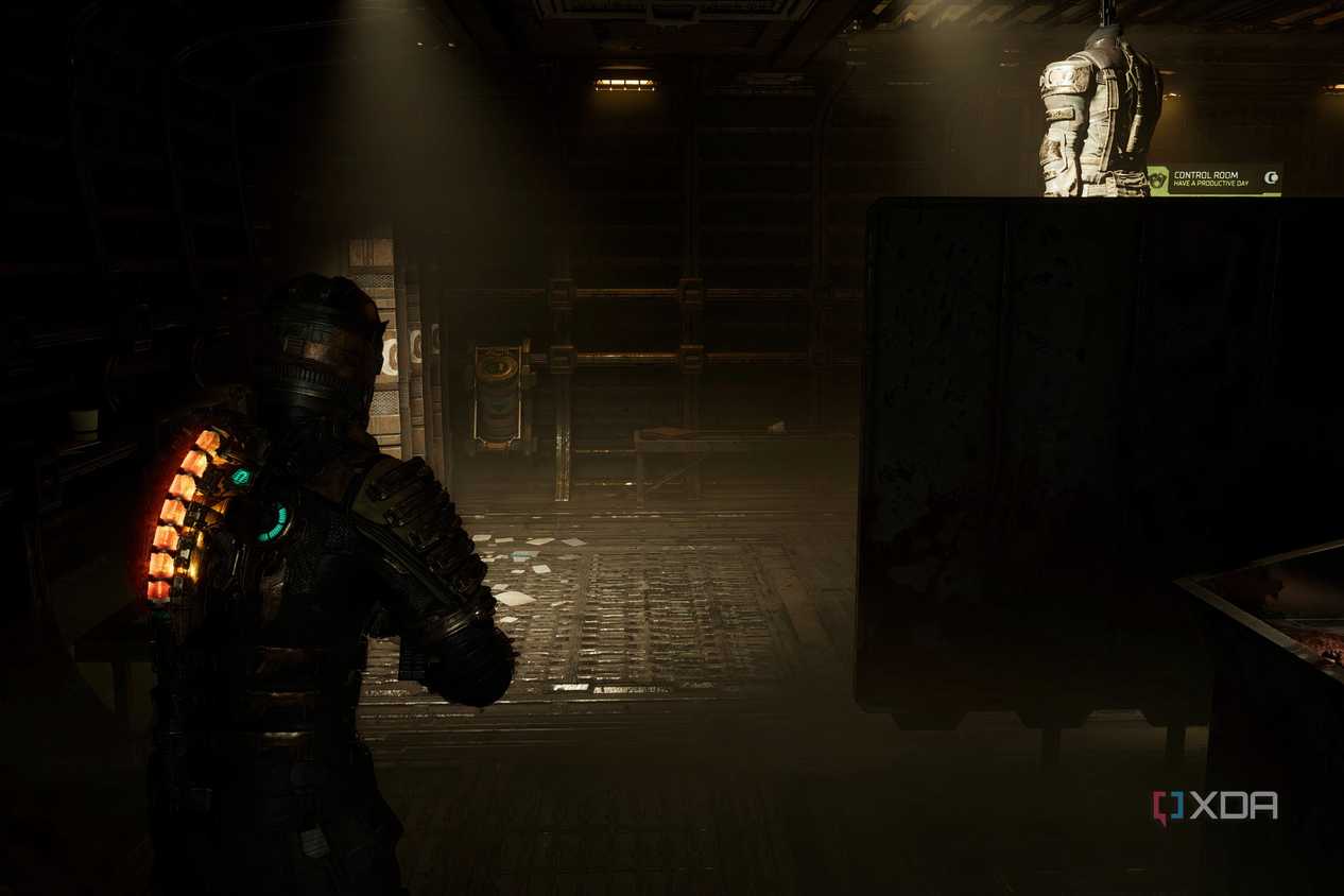 An image from 2023's Dead Space, showing the player character walking in a dark room.