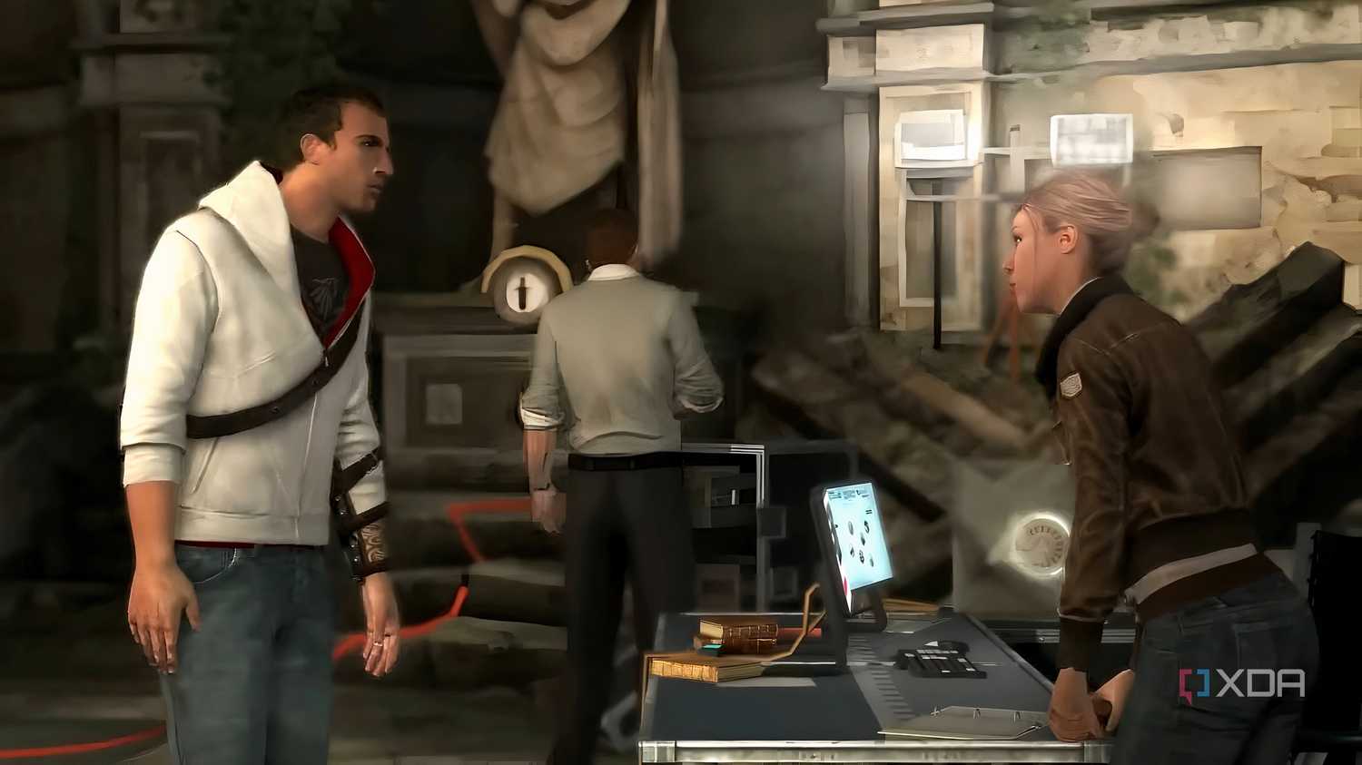 A screenshot from Assassin's Creed Brotherhood, showing Desmond and Lucy talking with Shaun in the background.