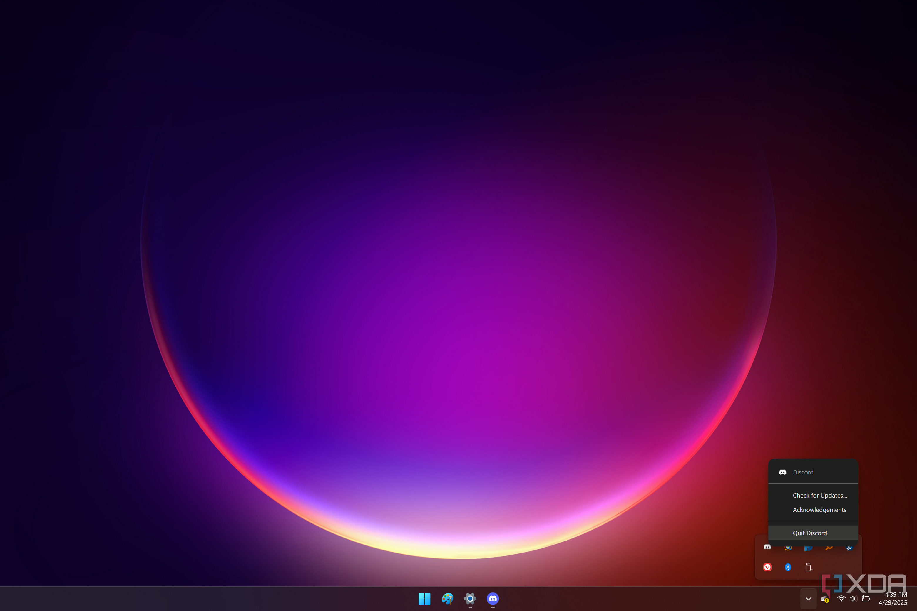 Screenshot of a Windows 11 desktop with a Discord flyout menu showing an option to quit the app