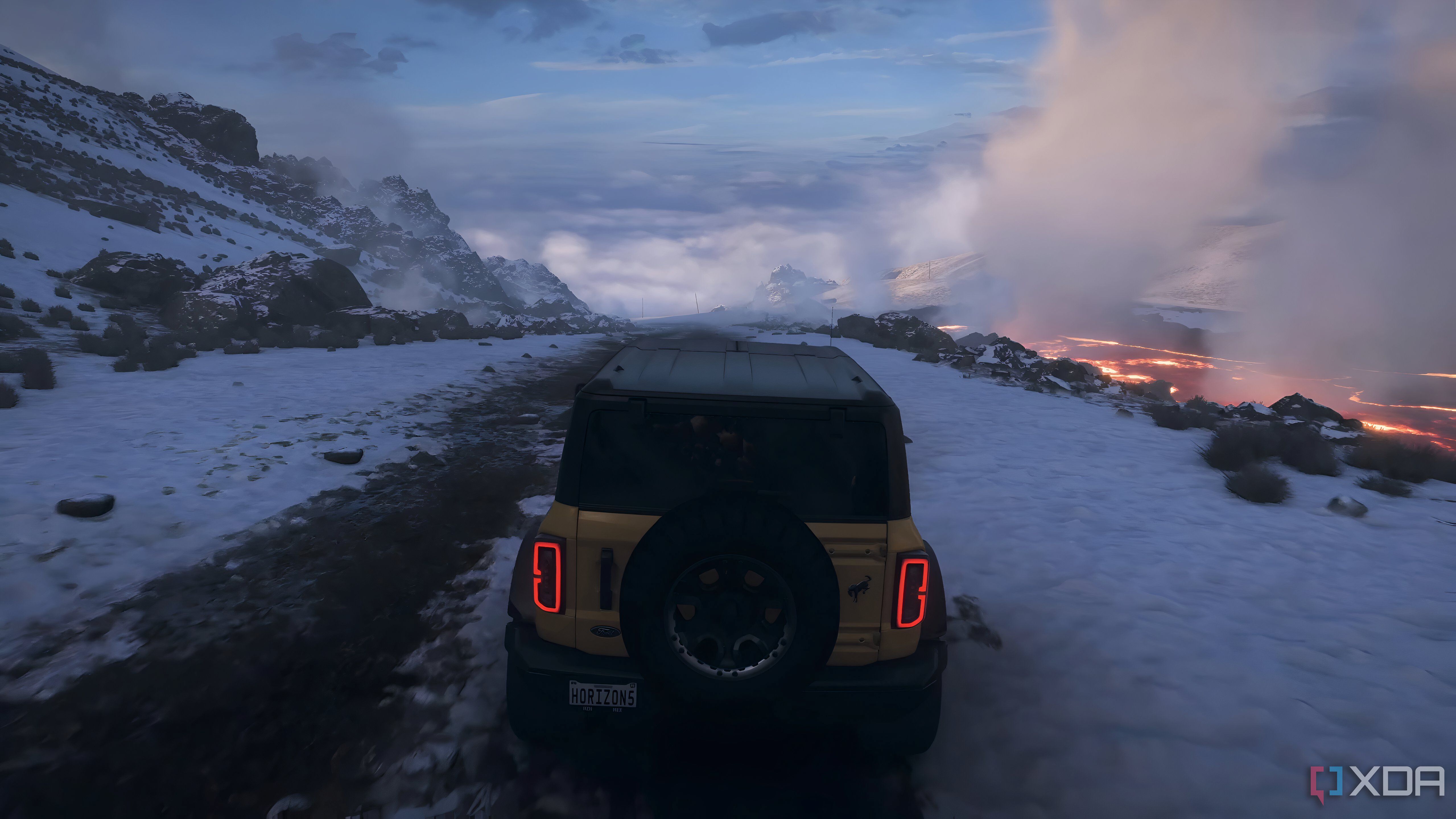 The opening of Forza Horizon 5, showing a yellow Ford Bronco driving down an icy mountain.