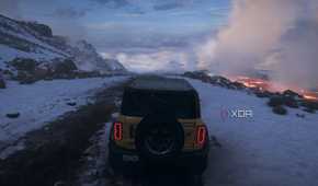 The opening of Forza Horizon 5, showing a yellow Ford Bronco driving down an icy mountain.