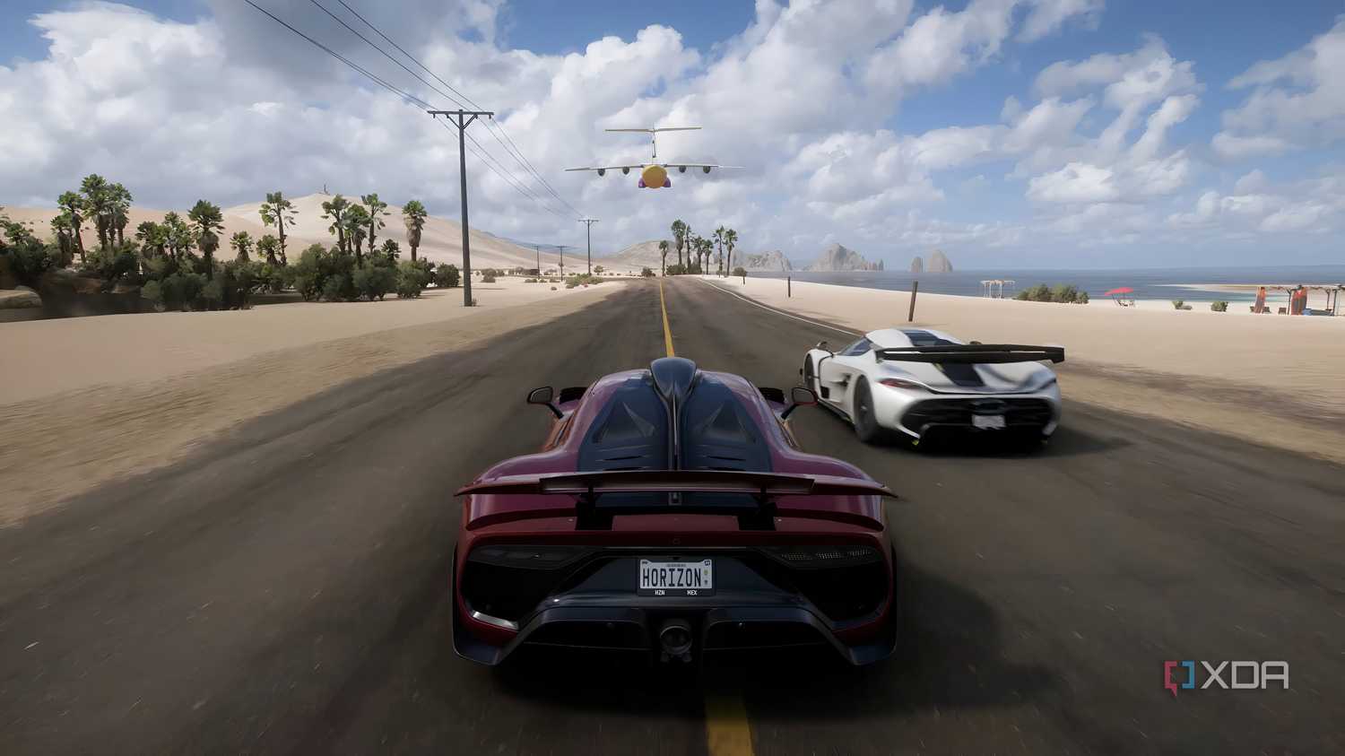The opening of Forza Horizon 5, showing a red Mercedes AMG-ONE racing along a beach.