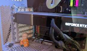 Close-up of a gaming PC showing a GPU next to a figurine