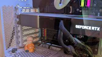Close-up of a gaming PC showing a GPU next to a figurine