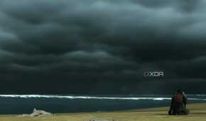 A screenshot from Ghost of Tsushima, showing Jin defeatedly sitting at Komoda beach, alone.