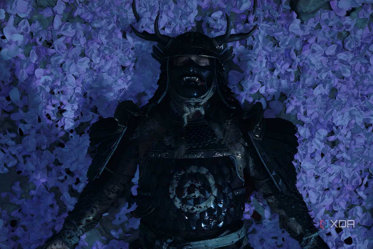 A screenshot from Ghost of Tsushima, showing Jin Sakai wearing Sakai armor and laying down on a bed of lilac petals.