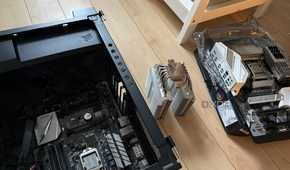 A photo of two motherboards and a CPU air cooler