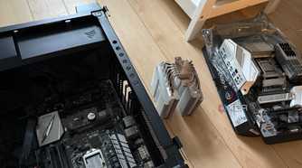 A photo of two motherboards and a CPU air cooler