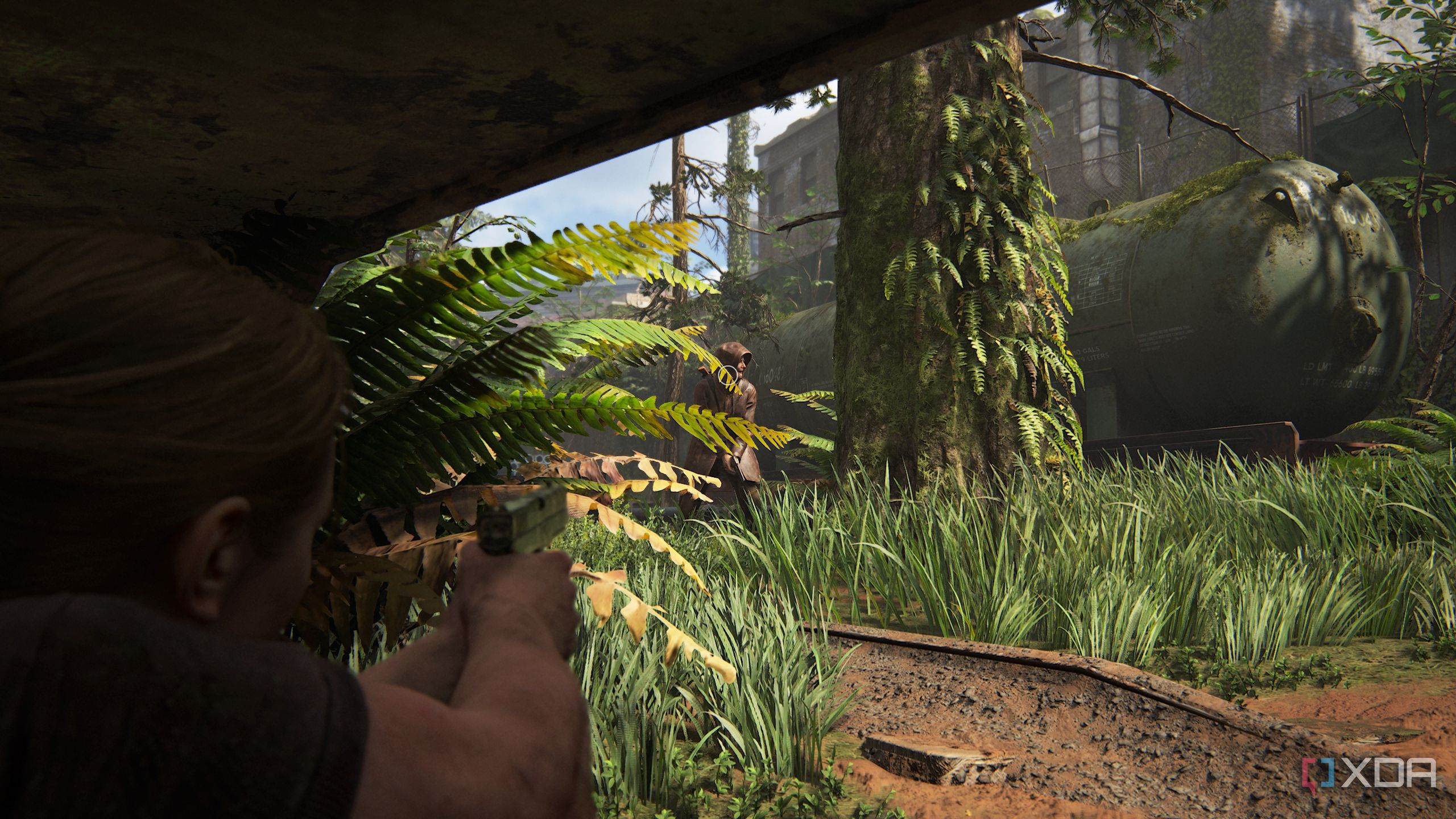 A screenshot from the game The Last of Us Part II, showing Abby aiming at an enemy.