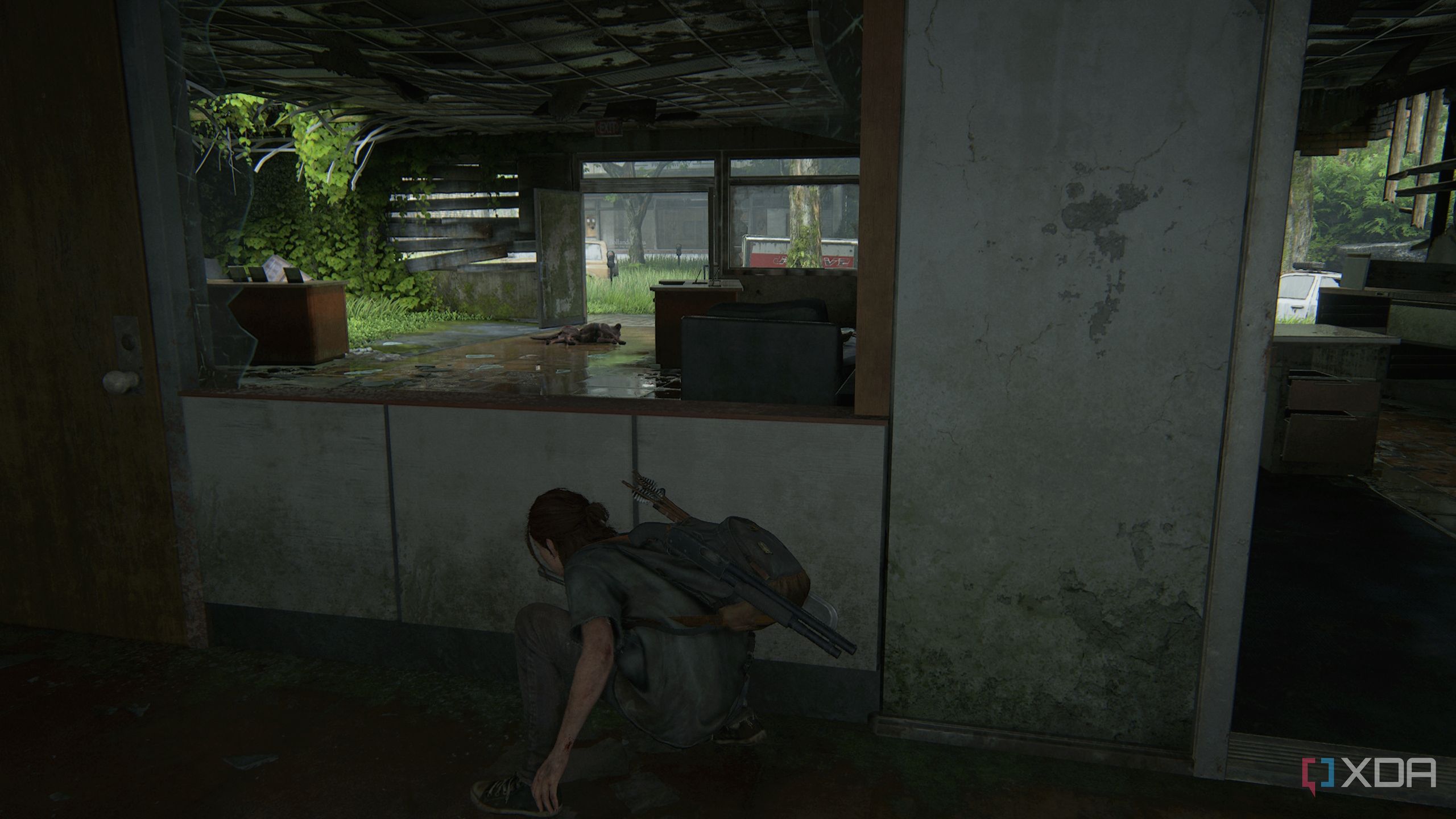 A screenshot from the game The Last of Us Part II, showing Ellie crouching in cover.
