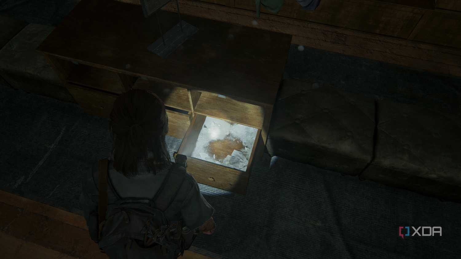 A screenshot from the game The Last of Us Part II, showing Ellie looking at an empty drawer.