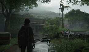 A screenshot from the game The Last of Us Part II, showing Ellie standing on an overturned vehicle.
