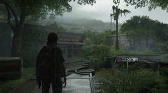 A screenshot from the game The Last of Us Part II, showing Ellie standing on an overturned vehicle.