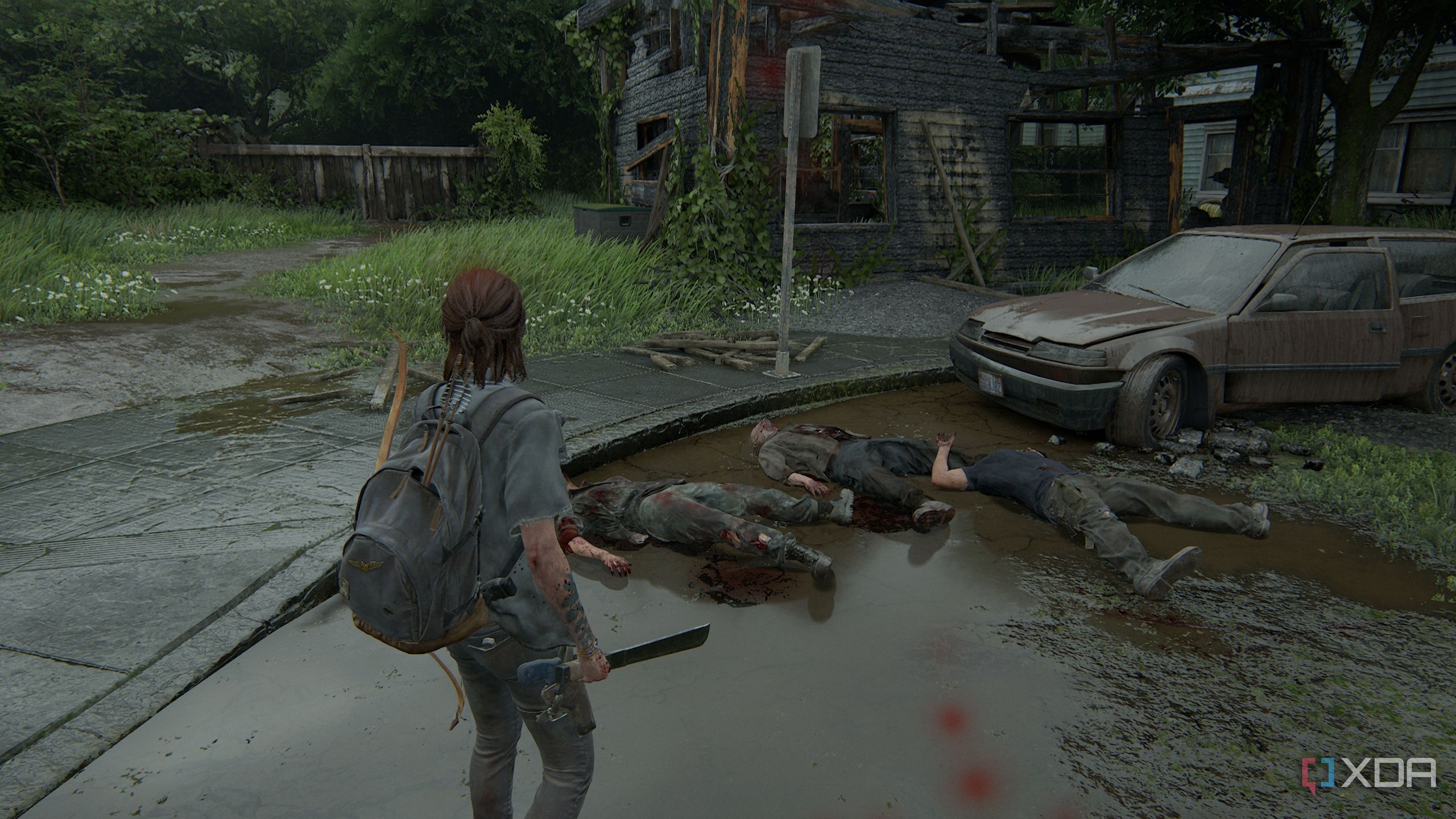 A screenshot from the game The Last of Us Part II, showing Ellie standing over three dead zombies.