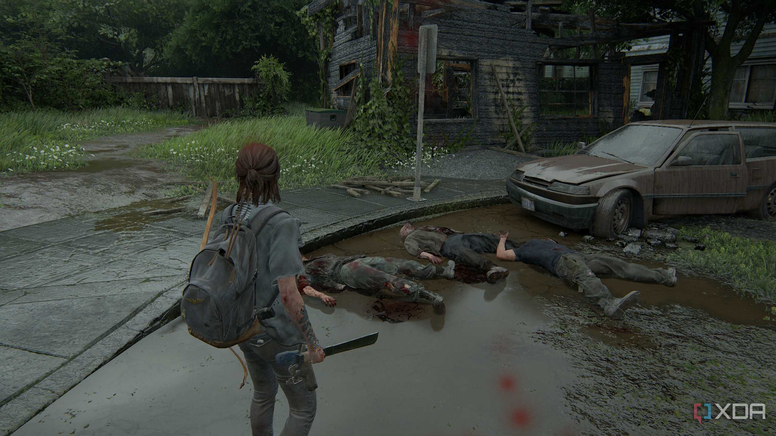 A screenshot from the game The Last of Us Part II, showing Ellie standing over three dead zombies.