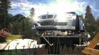 A screenshot from Need for Speed: Most Wanted showing a blue and white BMW M3 GTR jumping over a bridge with its headlights on.