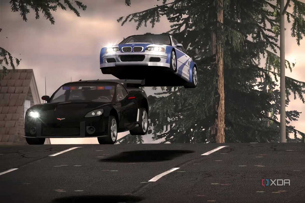 A screenshot from Need for Speed: Most Wanted 2005, showing a white and blue BMW jumping over a black Corvette.