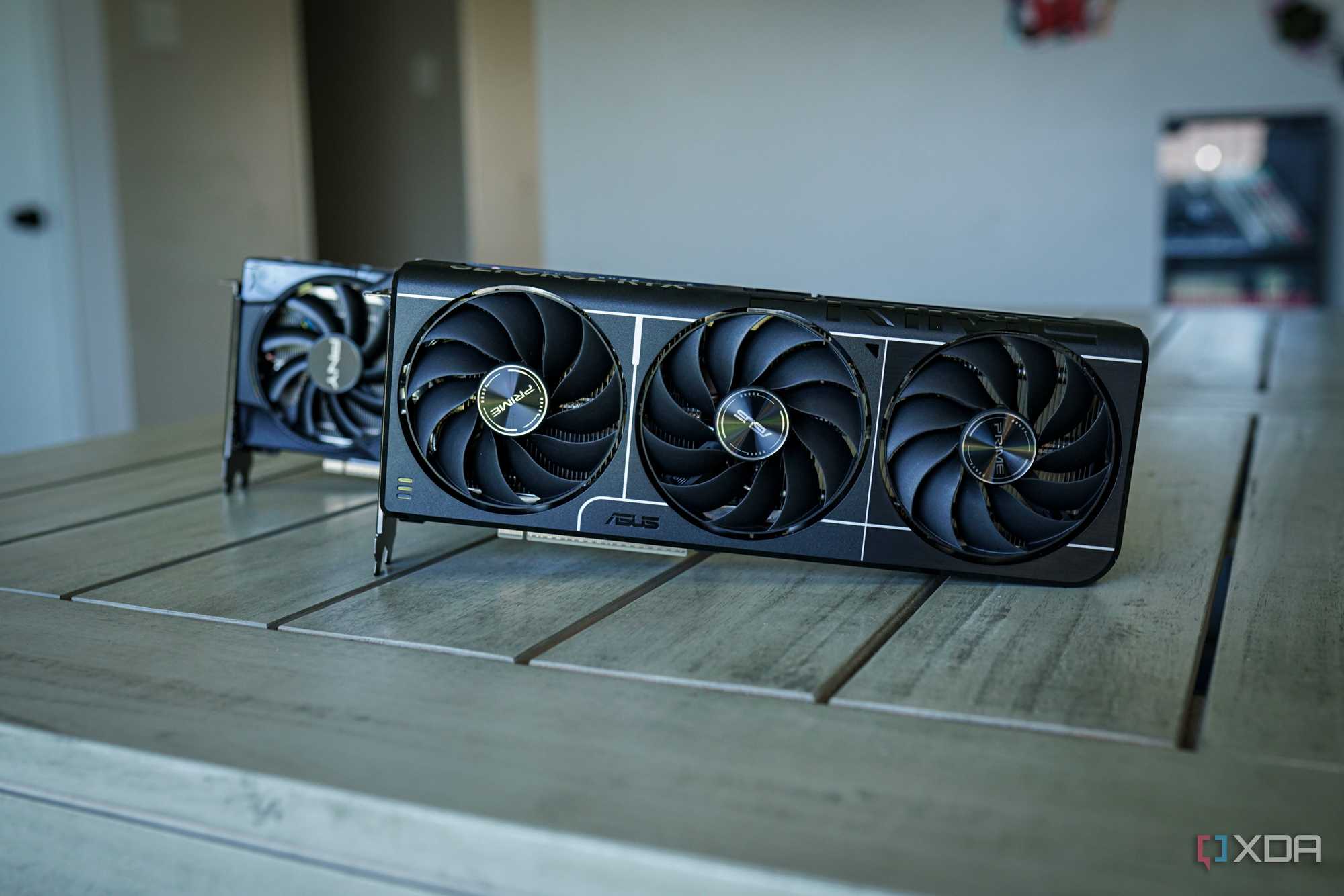 Two Nvidia RTX 5060 Ti GPUs sitting on a table.
