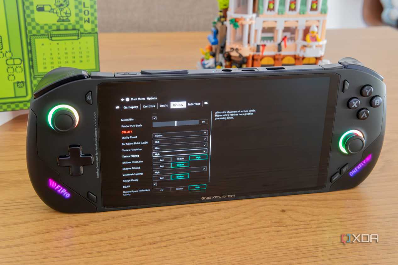 Angled front view of the OneXFly F1 Pro showing graphics settings for Control