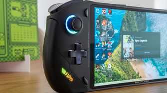 Close-up view of the OneXFly F1 Pro showing the left hand controls and the screen displaying the Windows 11 desktop