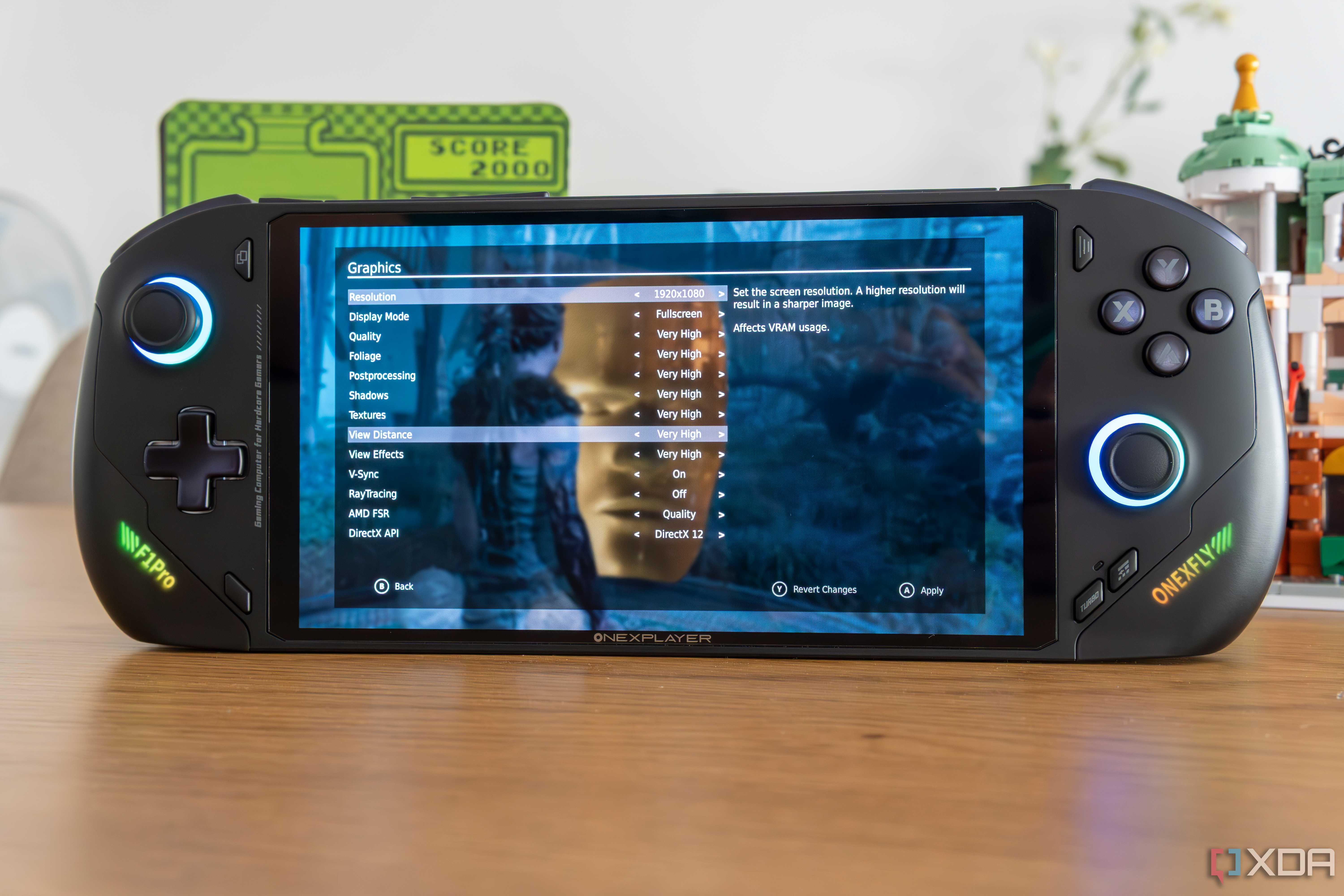Angled front view of the OneXFly F1 Pro showing graphics settings for Hellblade Senua's Sacrifice