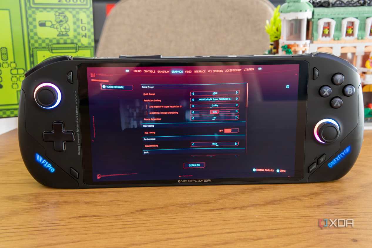 Angled front view of the OneXFly F1 Pro showing graphics settings for Cyberpunk 2077