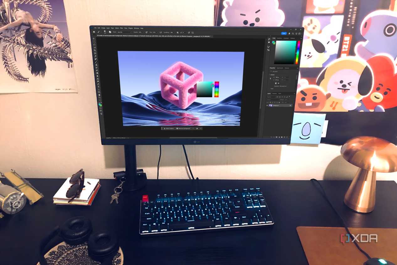 Photoshop displayed on desktop pc with posters,lamp, and headphones in view
