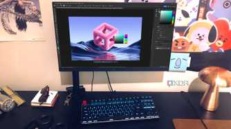 Photoshop displayed on desktop pc with posters,lamp, and headphones in view