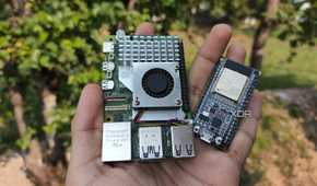 A person holding a Raspberry Pi and an ESP32