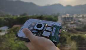 A person holding a Raspberry Pi and some storage drives